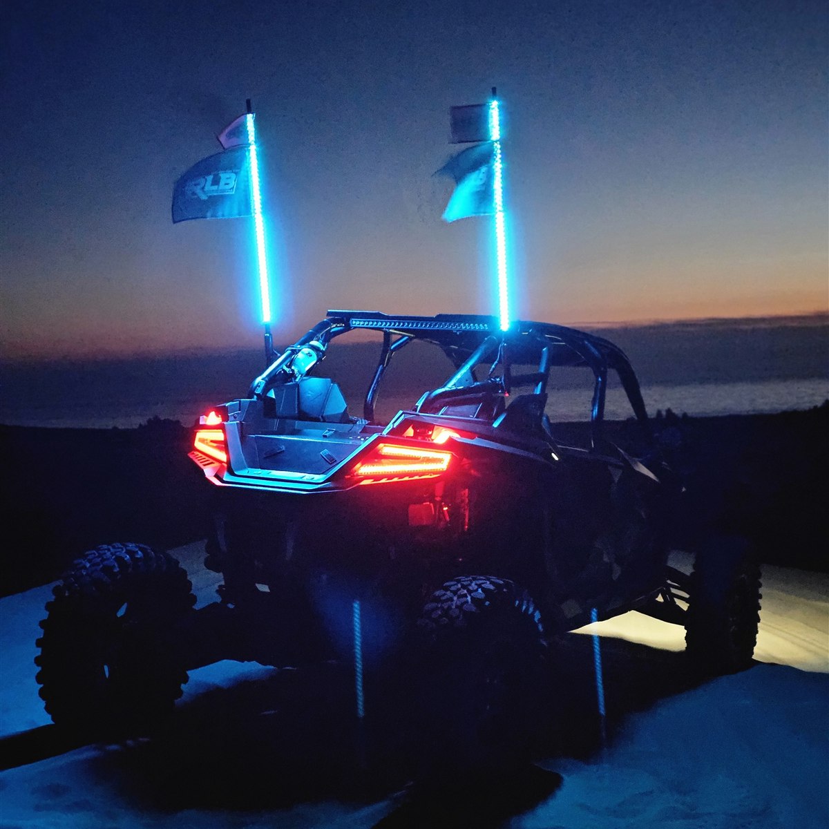 Red, white and blue LED whips on a UTV at dusk
